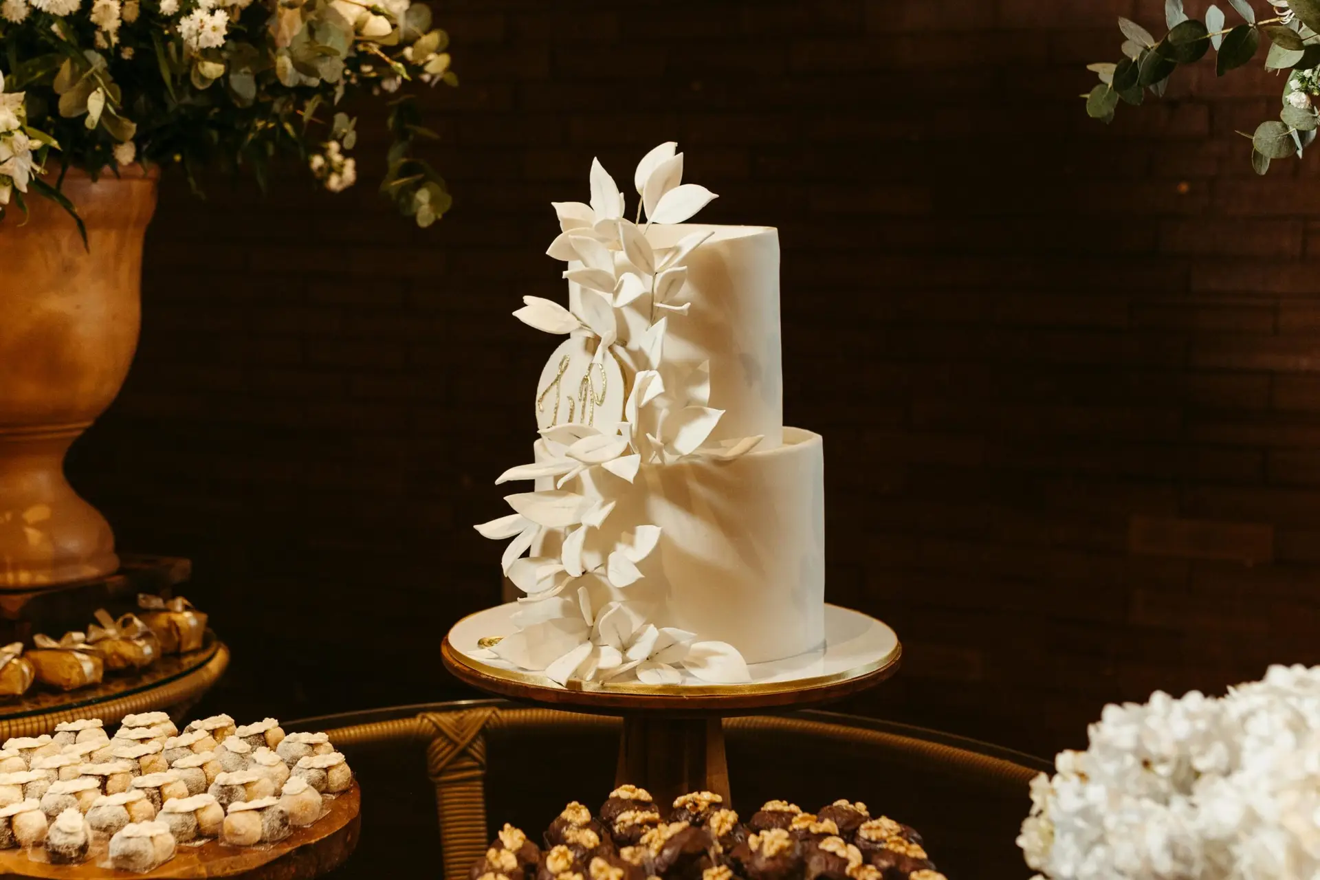 Sophisticated white wedding cake with delicate floral accents, perfect for elegant celebrations.