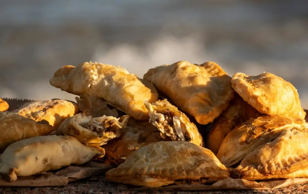 Golden baked empanadas filled with meat, placed by the seaside in Montevideo, Uruguay.
